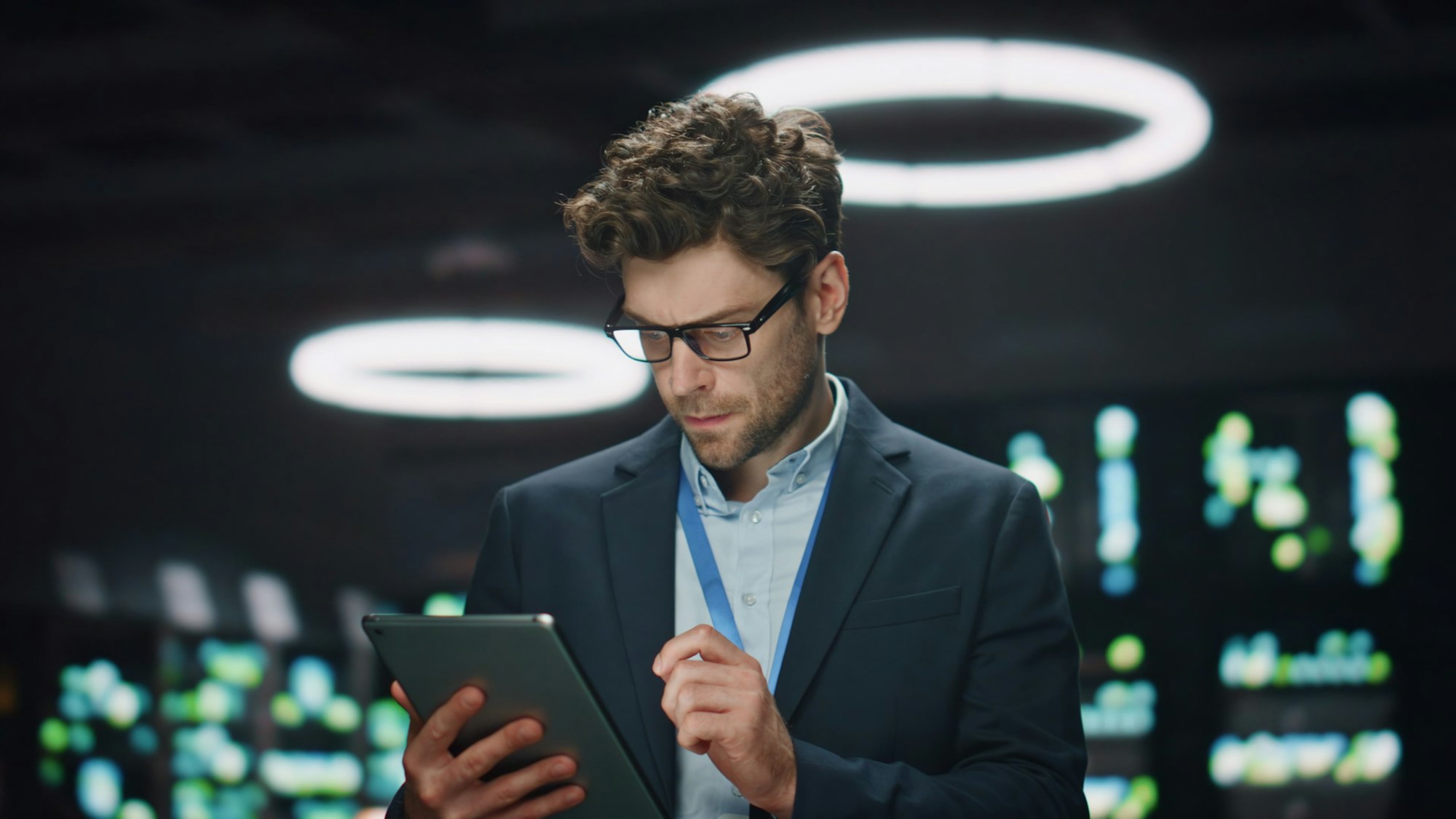 Focused IT man working tab computer at datacenter closeup. System administrator