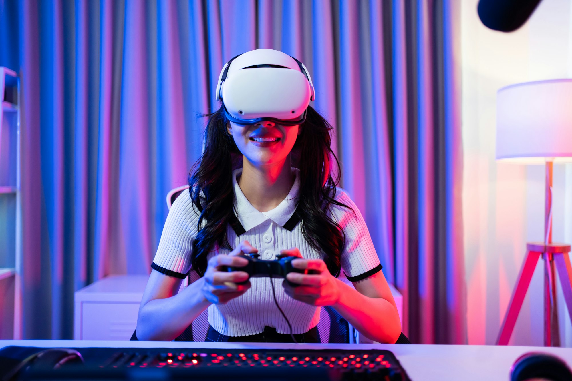 Asian young Esport woman gamer use technology VR glasses and play game.