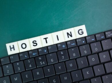 laptop keyboard and alphabet letters with the word hosting.